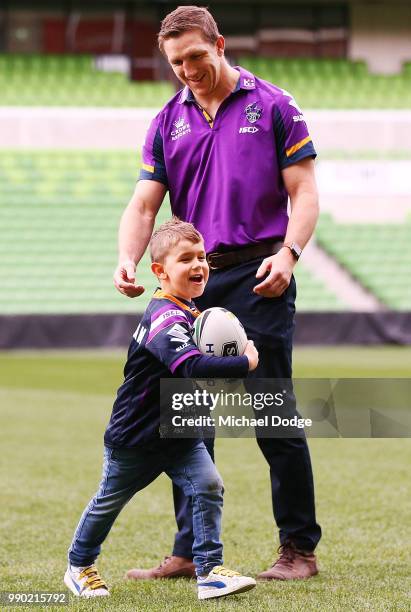 Melbourne Storm veteran Ryan Hoffman plays with his son Zach during a press conference to announcement his retirement on July 3, 2018 in Melbourne,...