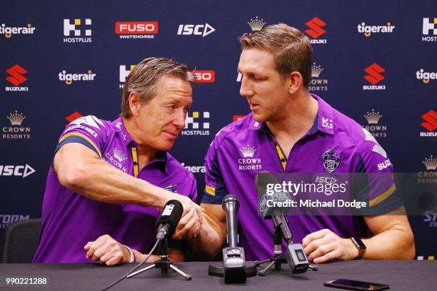 Melbourne Storm veteran Ryan Hoffman and head coach Craig Bellamy shake hands during a press conference to announce his retirement on July 3, 2018 in...