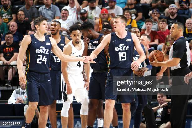 Grayson Allen high-fives Peyton Aldridge of the Utah Jazz during the 2018 Summer League at the Vivint Smart Home Arena on July 2, 2018 in Salt Lake...