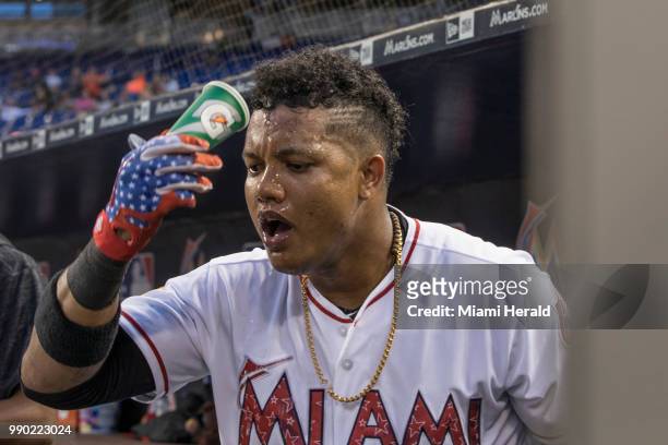Miami Marlins second baseman Starlin Castro cools himself off with a cup of water in the fourth inning against the Tampa Bay Rays at Marlins Park...