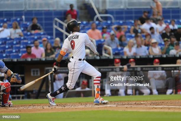 Miami Marlins center fielder Lewis Brinson hits a single in second inning against the Tampa Bay Rays at Marlins Park Monday, July 2, 2018 in Miami.