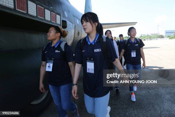 South Korean women basketball players walk to board a plane to leave for Pyongyang, in North Korea, to participate in inter-Korean basketball...