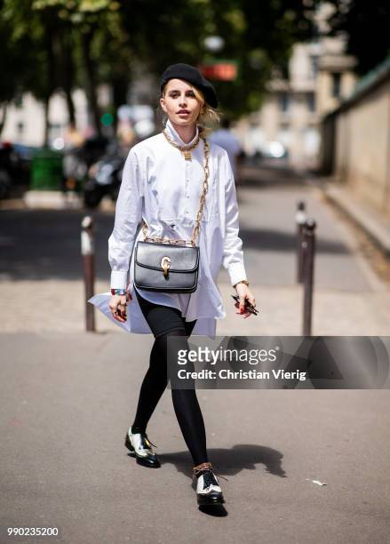 Caroline Daur wearing white button shirt, black beret, black leggings is seen outside Dior on day two during Paris Fashion Week Haute Couture FW18 on...