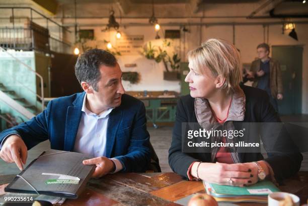 The heads of German party Alliance 90/The Greens, Cem Ozdemir and Simone Peter, talk as they prepare for the board meeting of their party at the...