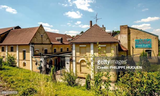 Picture shows the entrance of the Claeyssens de Wambrechies ditellery in Wambrechies, on June 28, 2018. - Classified as historic monument, the...