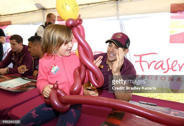 Billy Slater high fives young fan Mikayla Chapman during a Queensland Maroons Fan Day on July 3, 2018 in Hervey Bay, Australia.