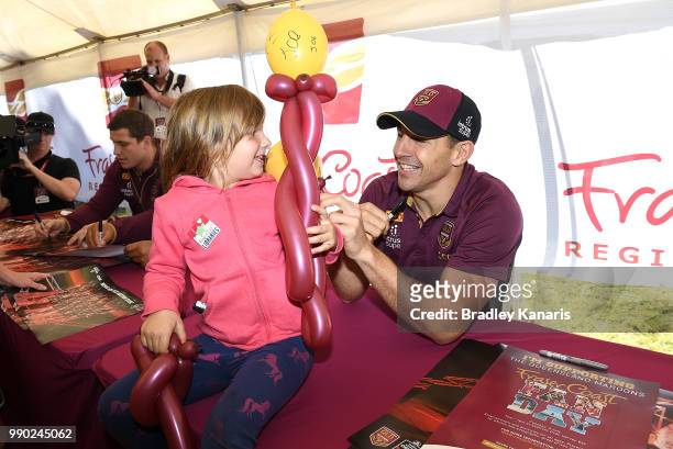 Billy Slater greets young fan Mikayla Chapman during a Queensland Maroons Fan Day on July 3, 2018 in Hervey Bay, Australia.