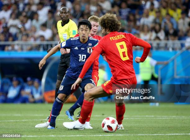 Shinji Kagawa of Japan between Kevin De Bruyne and Marouane Fellaini of Belgium during the 2018 FIFA World Cup Russia Round of 16 match between...