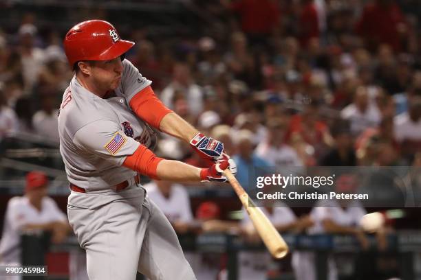 Jedd Gyorko of the St. Louis Cardinals hits a RBI single against the Arizona Diamondbacks during the first inning of the MLB game at Chase Field on...