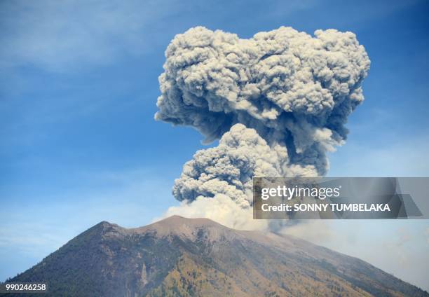 Plume of fresh ash is released as Mount Agung volcano erupts, in this image seen from the village of Tulamben in Karangasem Regency on Indonesia's...