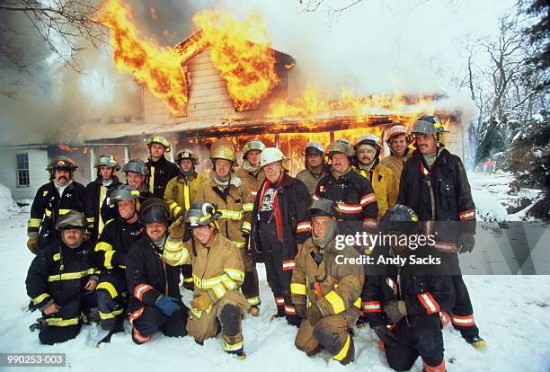 group of firefighters posing in front of burning house, winter - michigan winter bildbanksfoton och bilder