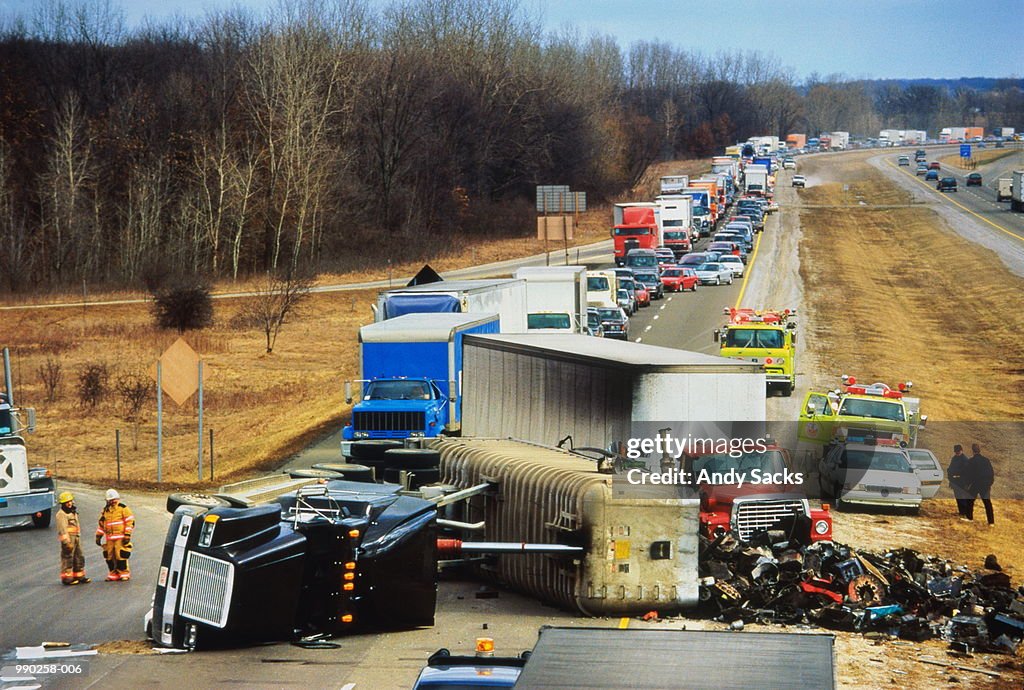 Truck overturned on highway, traffic jam behind