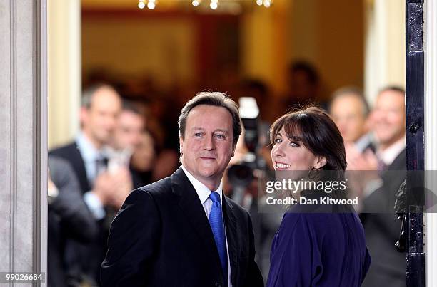 Prime Minister David Cameron and wife Samantha Cameron stand on the steps of Downing Street on May 11, 2010 in London, England. After five days of...