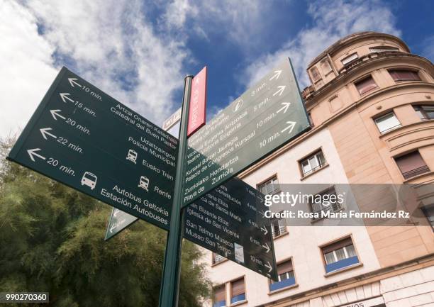 a view of some arrowtown signs that it indicates different important places in the city in san sebastian, guipúzcoa, spain - rz fotografías e imágenes de stock