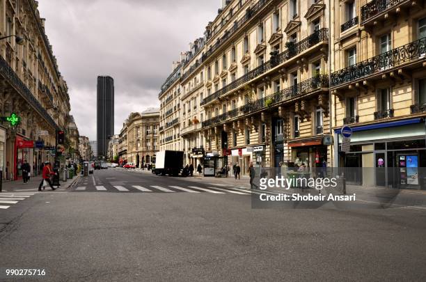 street of paris with montparnasse tower in background, paris - western european culture stock pictures, royalty-free photos & images