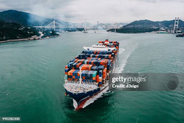 aerial view of container ship transporting goods sailing across ocean leaving the port - atlantic ocean bildbanksfoton och bilder