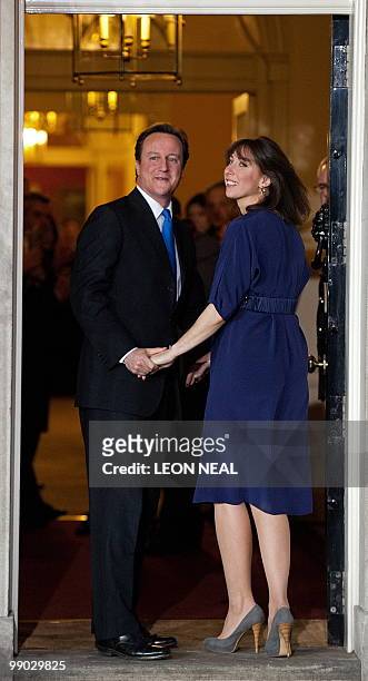 Britain's new Prime Minister, Conservative party Leader David Cameron, and his wife Samantha arrive in Downing Street, central London on May 11,...