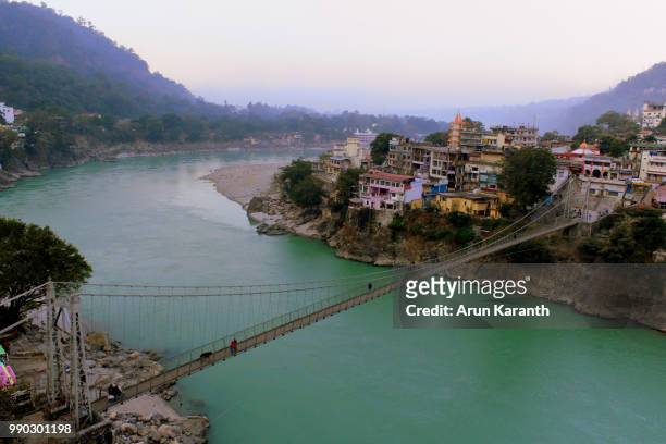 aerial view of bridge across ganga river in rishikesh - ganga stock pictures, royalty-free photos & images