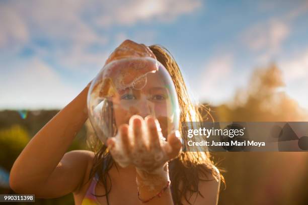 girl shows a big bubble of soap on her hands. - hot big women stockfoto's en -beelden