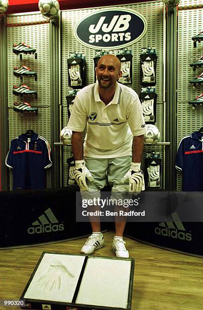 Fabien Barthez of Manchester United launches the Aquagrip Barthez goalkeeping gloves with an inprint in plaster at the JJB Adidas scoccer Dome,...