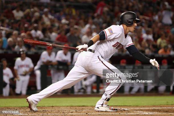 Jake Lamb of the Arizona Diamondbacks hits a RBI single against the St. Louis Cardinals during the first inning of the MLB game at Chase Field on...
