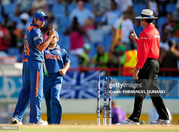 Indian player Suresh Raina checks with umpire Aleem Dar that there is one baal to be played during the ICC World Twenty20 Super Eight match between...
