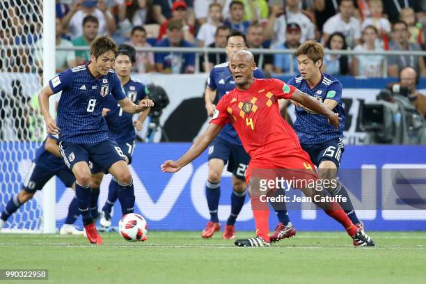Vincent Kompany of Belgium between Genki Haraguchi, Yuya Osako of Japan during the 2018 FIFA World Cup Russia Round of 16 match between Belgium and...