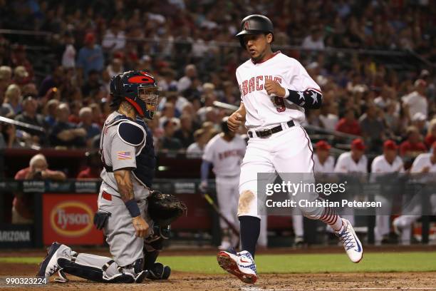 Jon Jay of the Arizona Diamondbacks scores a run past catcher Yadier Molina of the St. Louis Cardinals during the first inning of the MLB game at...