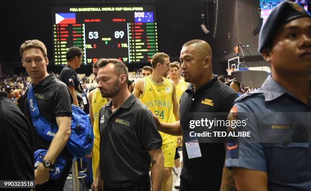 In this photo taken July 2 Australian players and officials leave the court after their FIBA World Cup Asian qualifier game against the Philippines,...