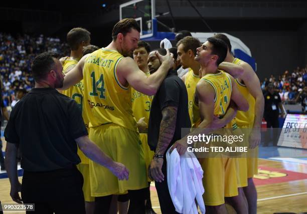 In this photo taken July 2 Australian players and officials gather at their bench after a brawl with Philippine players during their FIBA World Cup...