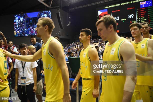 In this photo taken July 2 Australian players and officials leave the court after their FIBA World Cup Asian qualifier game against the Philippines,...