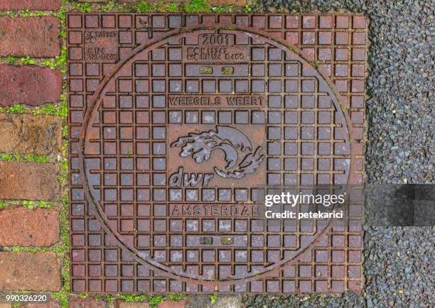 high angle view of text on manhole covering at street - vehicle hatch stock pictures, royalty-free photos & images