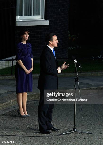 Conservative leader David Cameron speaks to the media as he becomes the British Prime Minister, as his wife Samantha looks on, in Downing St on May...