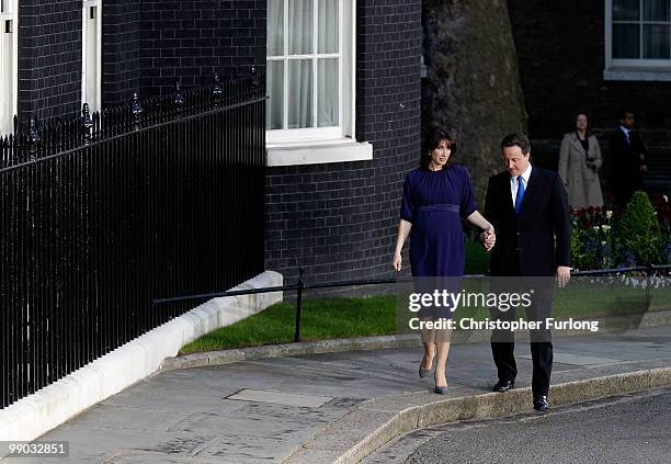 Conservative leader David Cameron and his wife Samantha arrive in Downing St as he becomes the new British Prime Minister on May 11, 2010 in London,...