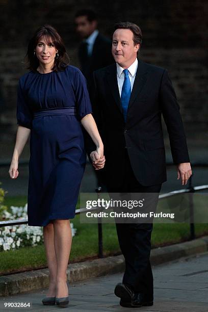 Conservative leader David Cameron and his wife Samantha arrive in Downing St as he becomes the new British Prime Minister on May 11, 2010 in London,...