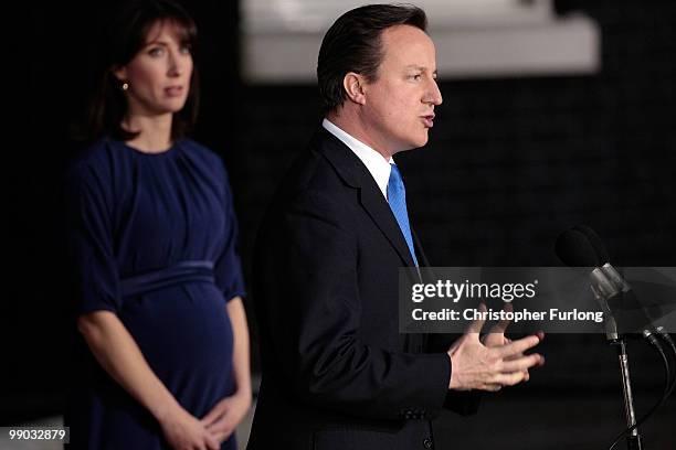 Conservative leader David Cameron speaks to the media as he becomes the British Prime Minister, as his wife Samantha looks on, in Downing St on May...