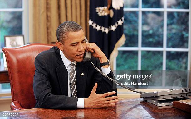 President Barack Obama calls to congratulate new British Prime Minister David Cameron in the Oval Office of the White House May 11, 2010 in...