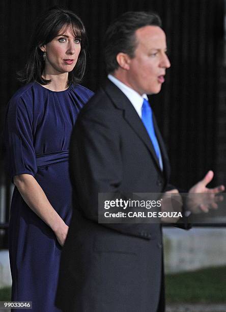 Britain's new Prime Minister, Conservative party Leader David Cameron, watched by his wife Samantha, addresses the media outside 10 Downing Street in...