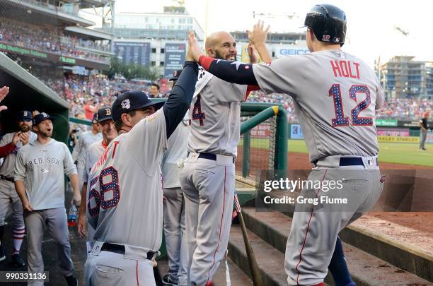 Brock Holt of the Boston Red Sox celebrates with teammates after scoring in the second inning against the Washington Nationals at Nationals Park on...