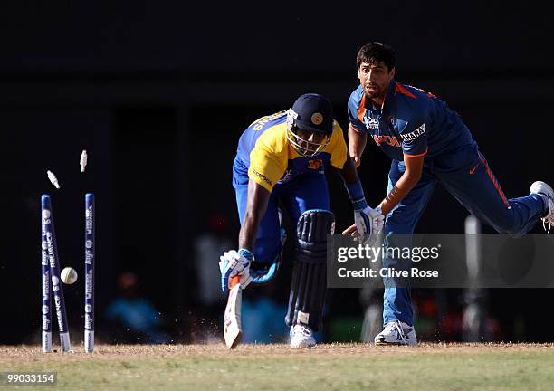 Angelo Mathews of Sri Lanka is run out by Ashish Nehra of India during the ICC World Twenty20 Super Eight match between India and Sri Lanka at the...