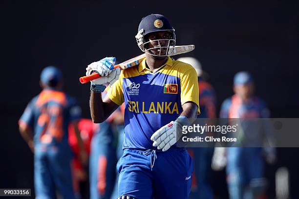 Angelo Mathews of Sri Lanka leaves the field after being run out by Ashish Nehra of India during the ICC World Twenty20 Super Eight match between...