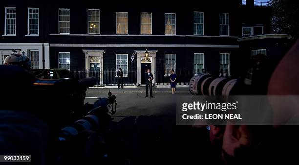 Britain's new Prime Minister, Conservative party Leader David Cameron, watched by his wife Samantha, addresses the media outside 10 Downing Street in...