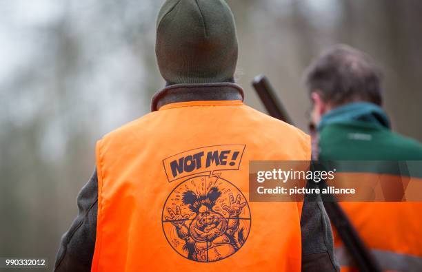 The vest of a hunter reads 'Not me' during a driven hunt across a forest near the motorway A2 in Bielefeld, Germany, 09 January 2018. Some 100...