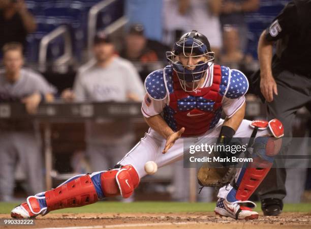 Realmuto of the Miami Marlins attempts to stop the throw in from the outfield in the ninth inning against the Tampa Bay Rays at Marlins Park on July...