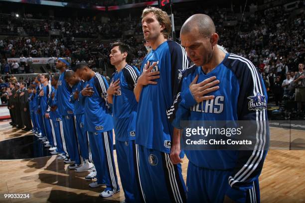 Eduardo Najera, Dirk Nowitzki and Jason Kidd of the Dallas Mavericks line up with their teammates for the singing of the national anthem at the start...