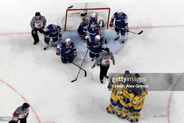 Carl Gunnarsson of Sweden celebrates his team's first goal with team mates as players of France react during the IIHF World Championship group C...