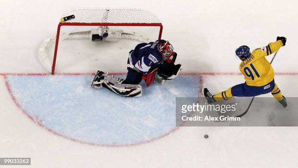 Magnus Paajarvi Svensson of Sweden tries to score with a shot between his legs against goalkeeper Eddy Ferhi of France during the IIHF World...
