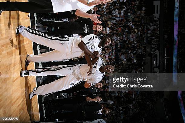 DeJuan Blair and Mahinmi of the San Antonio Spurs laugh as they look up at the scoreboard against the Dallas Mavericks in Game Six of the Western...