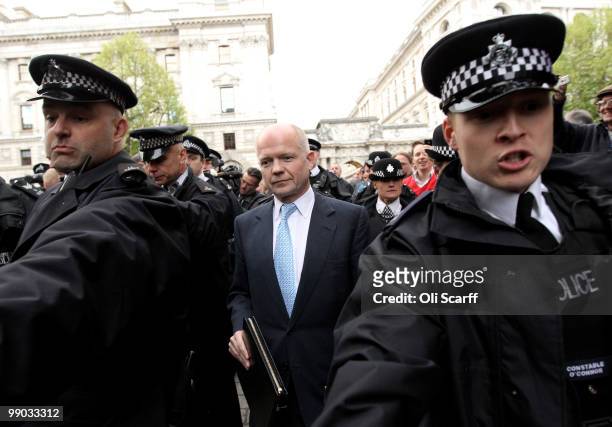 William Hague , the Conservatives Shadow Foreign Secretary, is escorted to Portcullis House by police following talks with a team of senior figures...