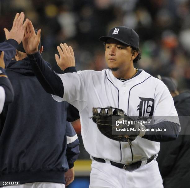 Miguel Cabrera of the Detroit Tigers high-fives teammates after the victory against the New York Yankees at Comerica Park on May 10, 2010 in Detroit,...